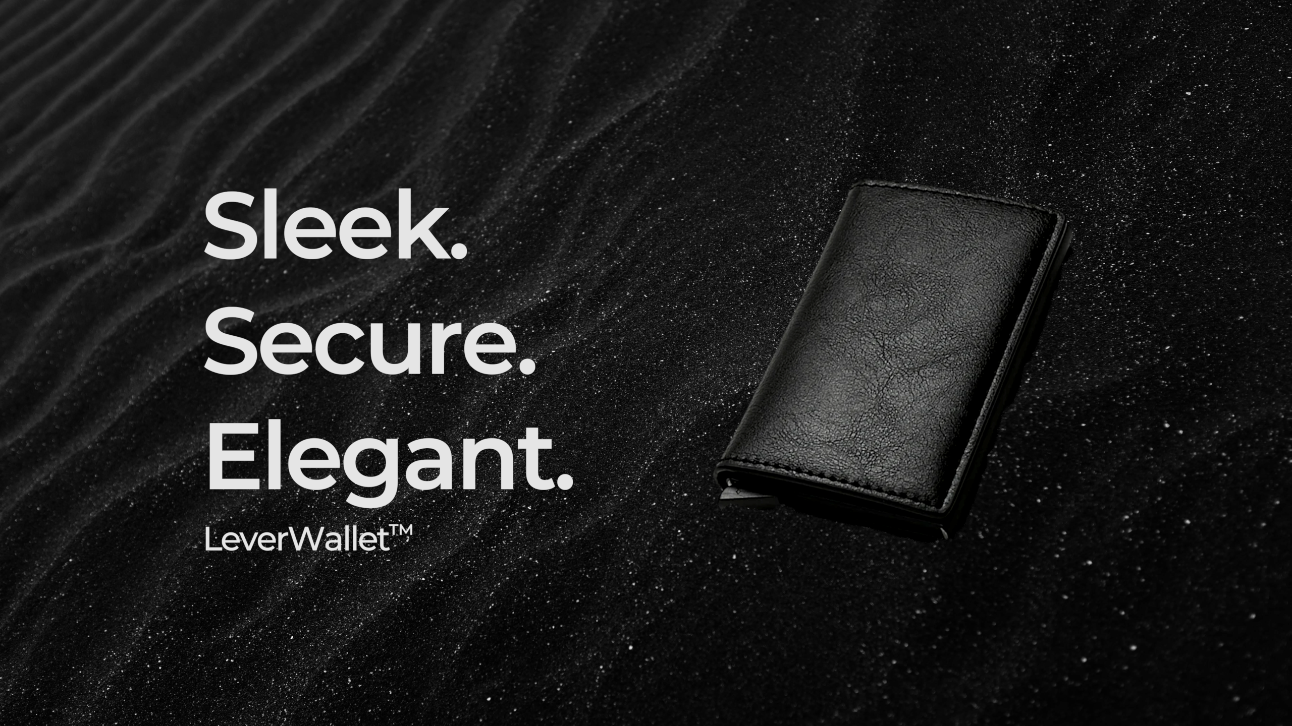 The sleek, secure, and elegant lever wallet lying in a bed of black sand.